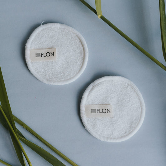 Two reusable FLON Bamboo Makeup Remover Pads made of white bamboo terry cloth, with the word ron on them.