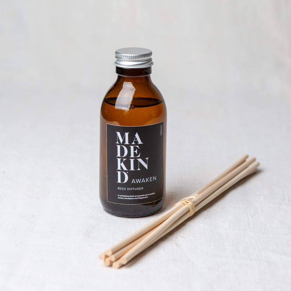MadeKind Awaken aromatherapy reed diffuser in glass amber bottle. Pure essential oil blend includes Lemon, Eucalyptus and peppermint. Reeds come included and presented in a Kraft gift box.