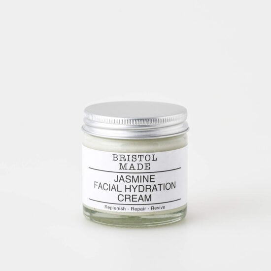 A 60ml clear glass jar of Bristolmade jasmine face cream, featuring a white label with black text, highlighting its vegan ingredients.