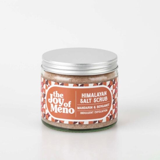 photo of a clear glass jar containing a pink coloured salt scrub for menopausal dry skin