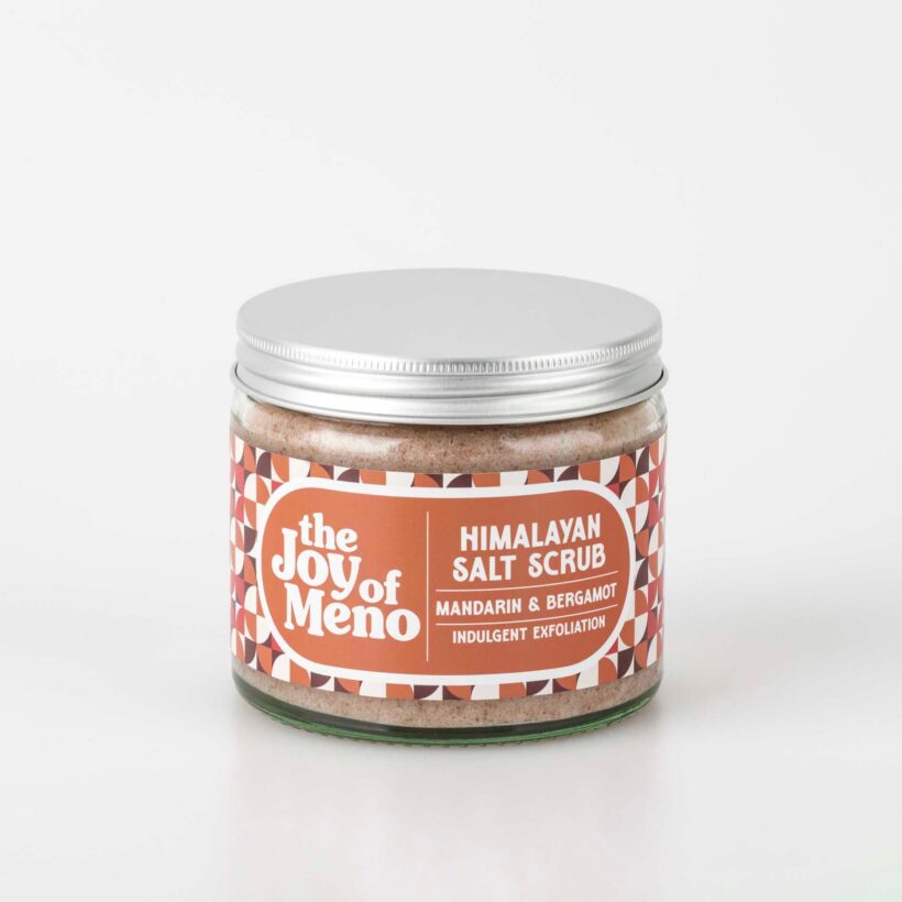 photo of a clear glass jar containing a pink coloured salt scrub for menopausal dry skin
