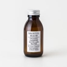 A 100ml amber glass bottle of Bristolmade Jasmin micellar Water, featuring a white label with black text, for cleansing and makeup removal with natural ingredients.
