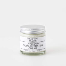 A 60ml clear glass jar of Bristolmade lavender face cream, featuring a white label with black text, highlighting it's vegan ingredients.