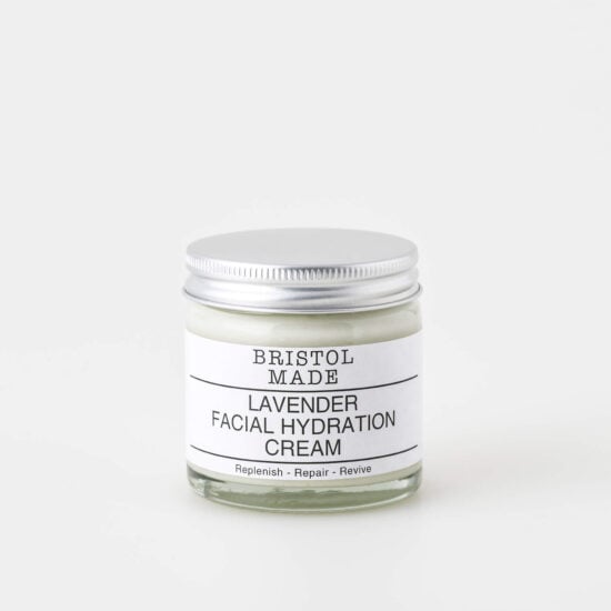 A 60ml clear glass jar of Bristolmade lavender face cream, featuring a white label with black text, highlighting it's vegan ingredients.