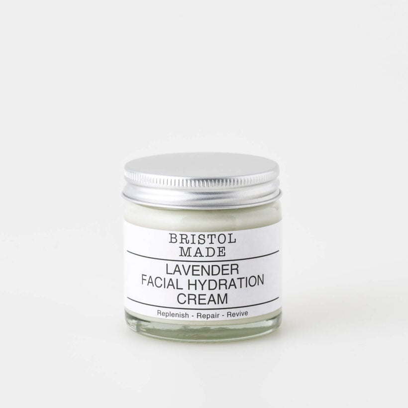 A 60ml clear glass jar of Bristolmade lavender face cream, featuring a white label with black text, highlighting it's vegan ingredients.