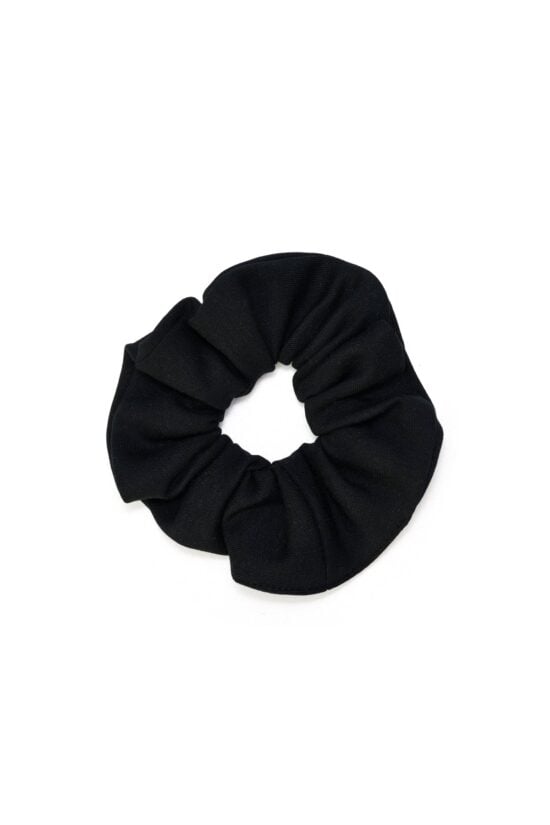 Eco-conscious black scrunchie made from biodegradable, Cradle to Cradle Certified® fabric by Wellicious – sustainable zero-waste hair accessory