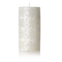 Large white double pillar candle with snowflake pattern on the side. When lit it glows through the pattern.