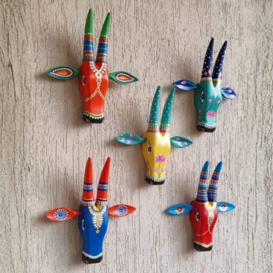 Several Hand carved Nandi Bull Wall Mask hanging décor in different colours and painted with designs and floral motifs
