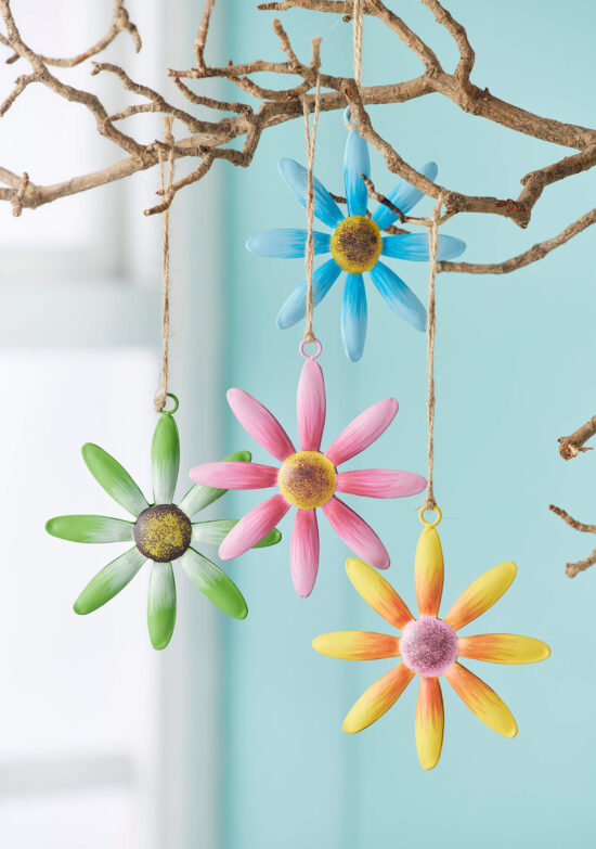 Hand-painted metal hanging daisy decoration s in blue, pink, green or yello, hanging from a branch